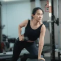 focused-young-asian-woman-exercising-600nw-2648005651